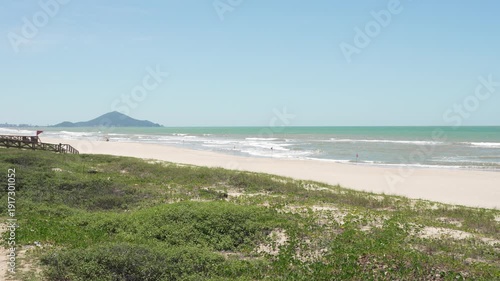 Navegantes, Brazil beach with lifeguard tower and distant hills.