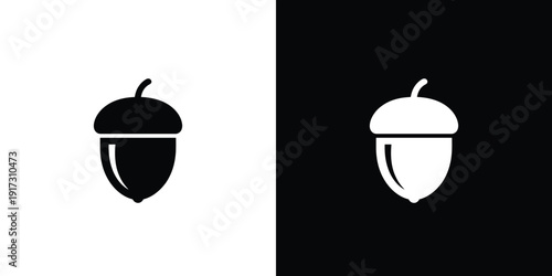 Black and white acorn on split color background symbol
