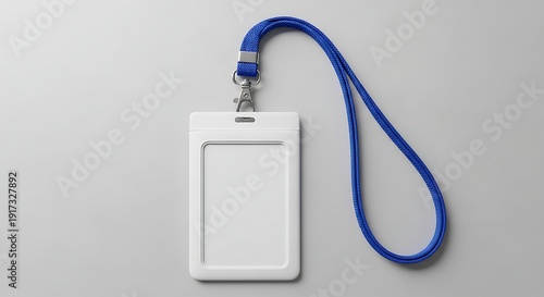A white identification badge with a blue lanyard on a gray background