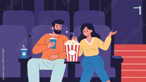 Happy couple enjoying a movie night at the cinema with a large bucket of popcorn and soft drinks in comfortable theater seats.