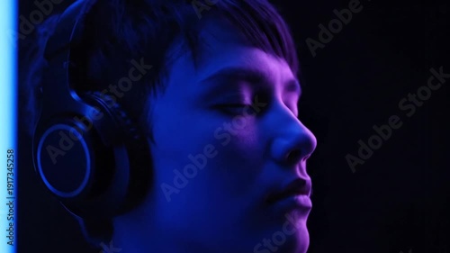 Man Wearing Headphones in Dark Room.