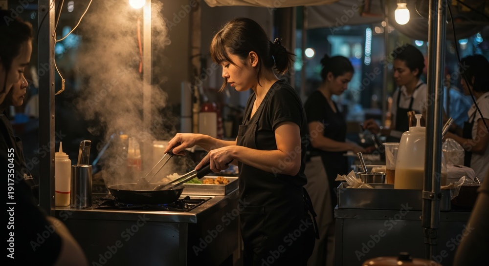 Obraz premium Sizzling Street Food Scene: Capturing the bustling energy of a street food vendor, amidst the rising steam and the warm glow of the lights, creating a sensory experience.