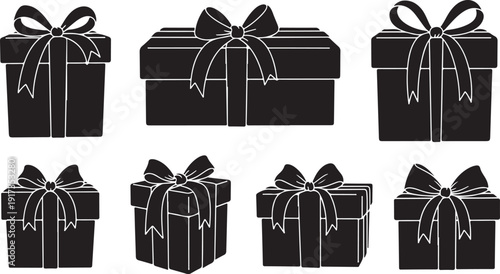 Black gift boxes with ribbons and bows on white