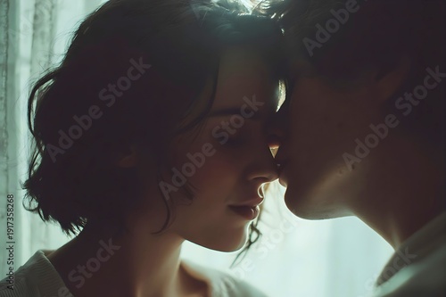 Romantic couple sharing intimate moment foreheads touching soft natural light