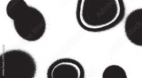 Abstract black spray paint stains and rings on white background.