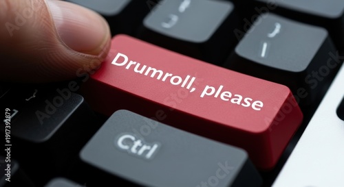Finger Pressing Red Drumroll, please Button on Computer Keyboard