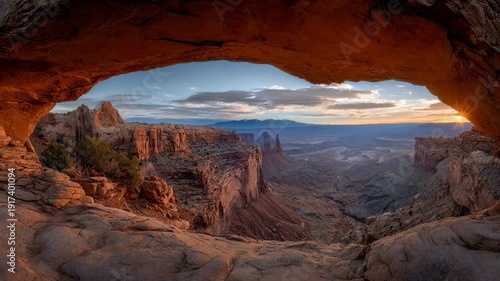 Mesa arch panorama at sunrise, golden light over canyon landscape, canyonlands national park, utah, usa scenic outdoor travel nature background