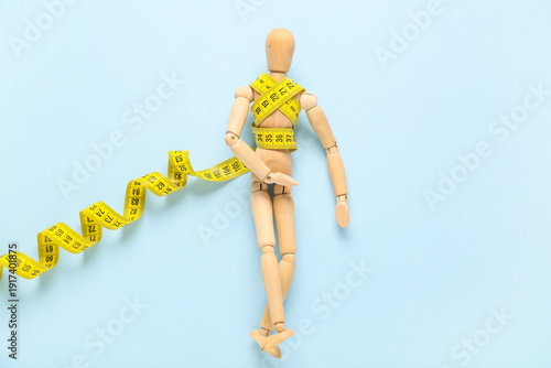 Wooden mannequin with yello...