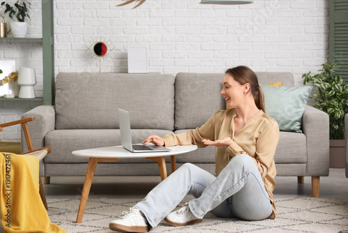 Young woman using laptop wh...