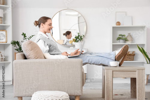 Smiling young woman using l...