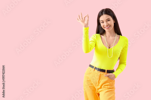 Young woman showing OK on p...