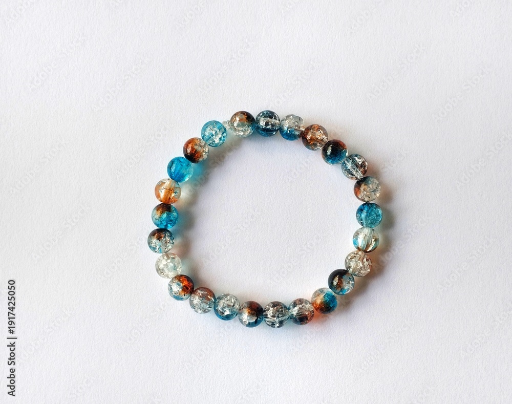 Fototapeta premium Multicolored handmade beaded bracelet with artistic texture isolated on white background.