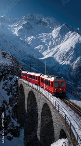 A vivid red train crosses a gracefully arched bridge high in the Swiss Alps