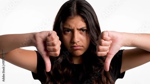 A young girl with long dark hair looks directly at the camera with a neutral