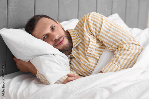 Young man in pajamas lying ...