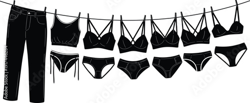 Minimalist black women clothing and lingerie collection hanging on clothesline, including jeans, crop top, bras and panties isolated on white background fashion concept