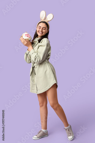 Happy young woman in bunny ...