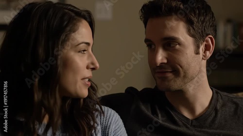 Wallpaper Mural A cheerful young couple shares a heartfelt conversation, smiling and laughing together in their comfortable home. Torontodigital.ca