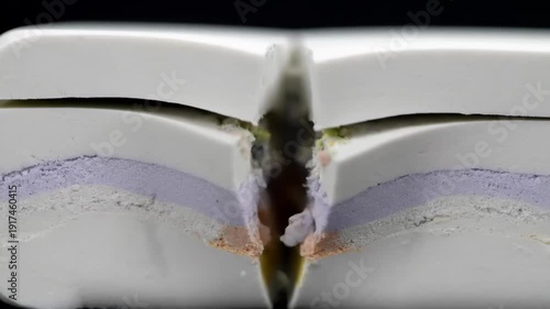 Wallpaper Mural A detailed macro view of a delightful layered dessert being precisely cut, showcasing its intricate and colorful interior layers. Torontodigital.ca