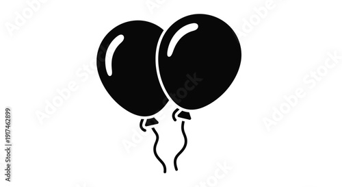 Two black balloons floating with delicate strings a stark silhouette