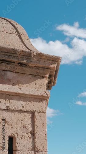 Detailed view of loophole architecture detail in Palma de Mallorca, Majorca, Spain. Clear blue sky and white clouds.