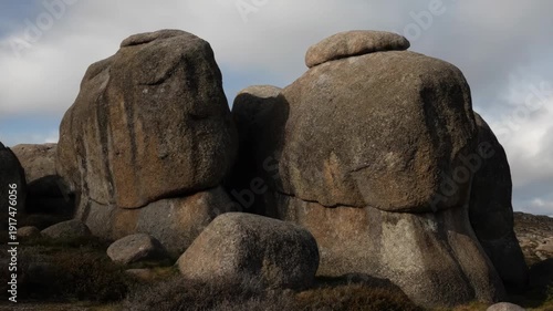 Wallpaper Mural A time-lapse captures the changing light and shadows on ancient granite boulders in a wild, rocky environment. Torontodigital.ca