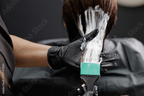 Canvas Print Female hair keratin treatment application on dark hair at salon