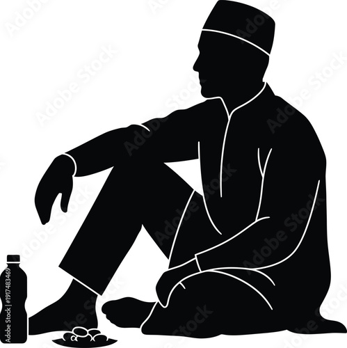 A man sitting on the floor with a bottle beside him, lost in thought.