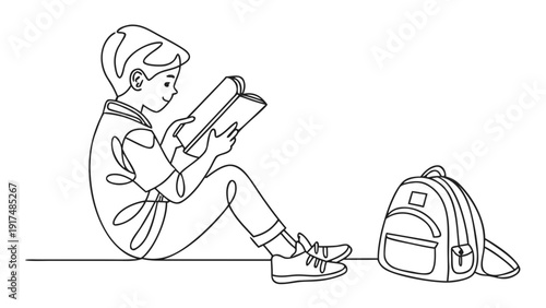 Young student reading book sitting with backpack beside him