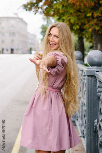 Playful Woman In Stylish Pink Dress In City