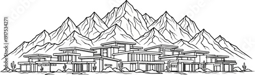 Modern desert homes nestled below majestic, jagged mountain peaks