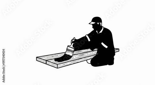 Person in dark clothes and cap painting wooden planks