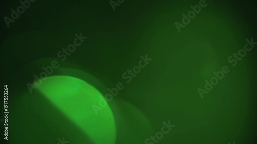 light leak and bokeh overlay with green hues, capturing soft glowing circles and lens flares. This footage is ideal for adding atmospheric effects to videos.