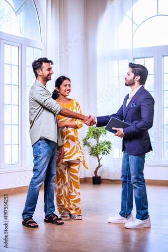Indian Young homebuyers finalizing property agreement after successful consultation