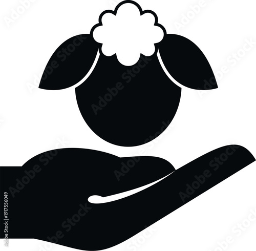 Hand holding a sheep head, symbolizing animal care, protection, and welfare