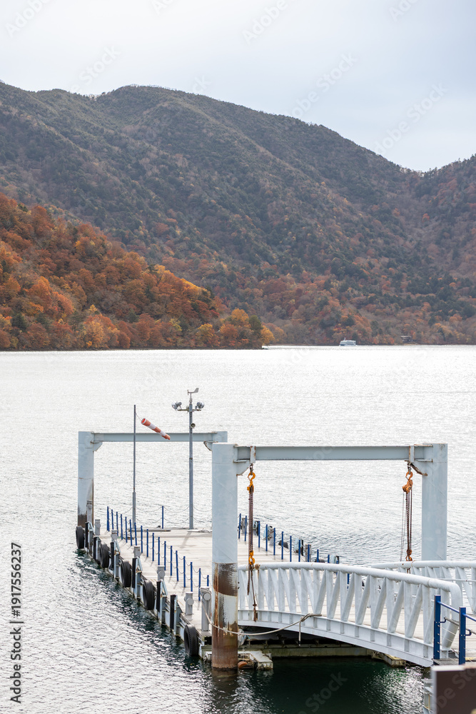 Fototapeta premium landscape view of Lake Chuzenji (Chuzenjiko) at Cruise Boat Passenger Terminal Nikko, Tochigi, Japan during autumn.