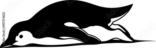 Dark outline of a penguin gliding on its stomach over a snowy surface