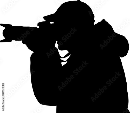 Silhouette of a professional photographer with a camera and telephoto lens