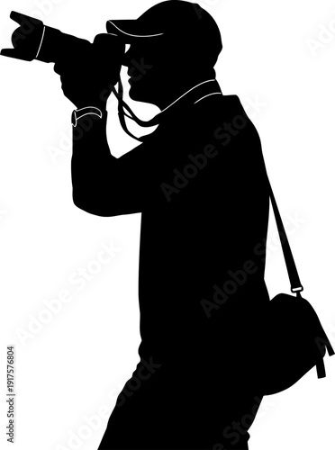 Silhouette of a professional photographer holding a camera with a large lens