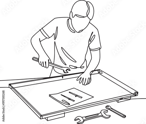 Man assembling furniture with tools instruction manual and wrench
