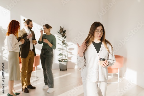 Photos Employee feeling excluded during office coffee break