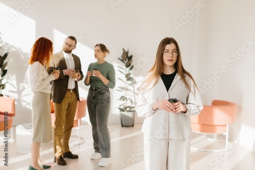 Fotografie Young woman feeling excluded during business office break