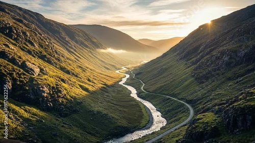 Sunlight streams through the valley, illuminating the winding river below.