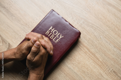 Wallpaper Mural Old man hands clasped prayer with Holy Bible for Christian faith, spirituality, worship, devotion, hope, and religious belief, prayer time in church, trust in God, and spiritual guidance. Torontodigital.ca