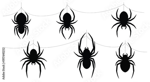 Halloween spider decorations hanging from strings a dark silhouette
