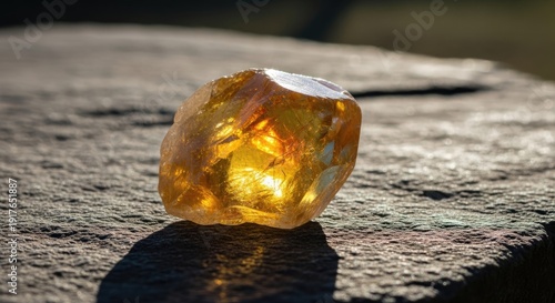 Golden Gemstone Shines Brightly on Stone Surface.