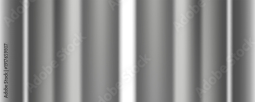 A detailed close-up of a brushed metal surface, showcasing its fine linear grain and subtle variations in light and shadow, perfect for industrial or modern themes.