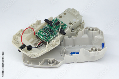 Disassembled quadcopter drone with circuit board isolated on white