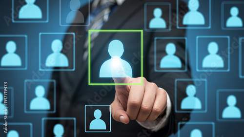 Businessman hand touching virtual screen with glowing human icon selecting individual for team