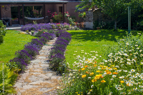 Wallpaper Mural rustical garden - stone paved garden path and flowers - summertime Torontodigital.ca